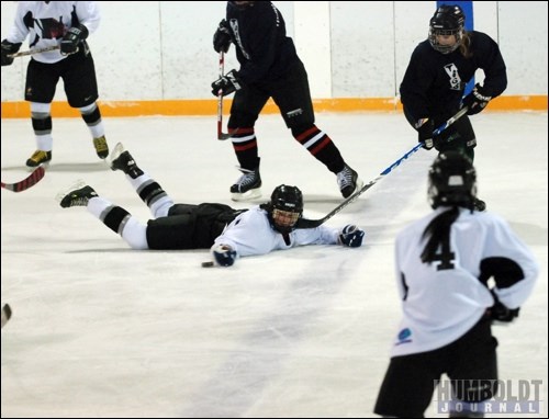 A member of the Daisy Dukes hockey team is down, but not out as she uses her glove to move the puck while sprawled on the ice with a stick in her face. The Dukes were playing a team from Tisdale in a women's hockey game in Watson on December 12.