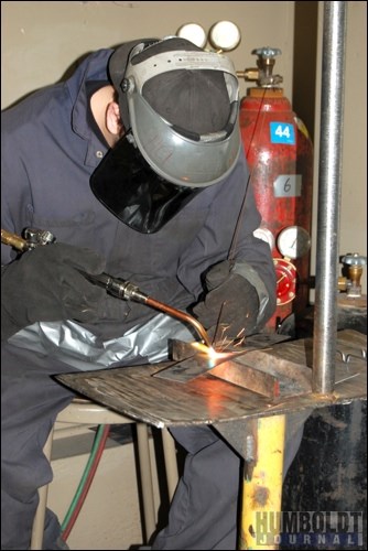 A student from HCI sheds some sparks off a welding mask as they do some oxyacetylene welding on December 20. The students were at the CTRC welding shop to help celebrate its recent renovations.