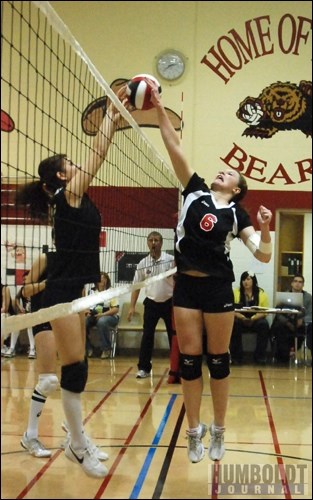 Brooklyn Carberry (6) of the Bruno Bears tries to tip the ball over the net and a member of the Wolseley Warriors during a volleyball game on November 19 in Bruno. The two teams were competing in the 2A girls' Provincial Volleyball championships.