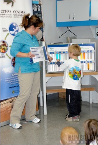 Kendra Ulmer shows how difficult it is to tell the difference between harmful chemicals and liquids safe to drink at the Farm Safety Day.