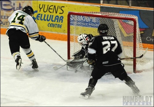 Taylor Johnson (14) of the Humboldt Broncos is denied a goal by Battlefords North Stars goaltender Graham Hildebrand.