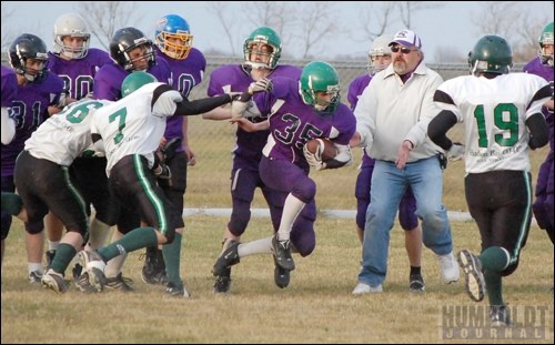 Anthony Talbot (35) of the Lakeside Bombers gets pushed out of bounds in front of his bench by Dalton Kolybaba of the Hudson Bay Riders.