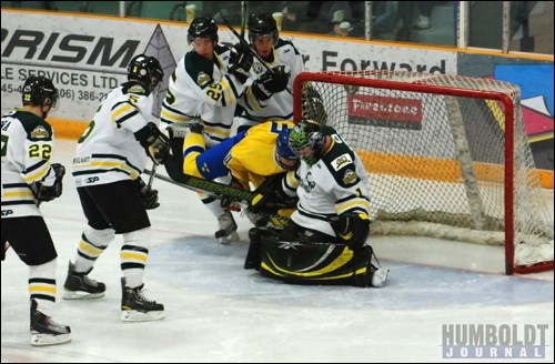 Swedish player David Gunnarsson falls into Humboldt Broncos goaltender Andrew Bodnarchuk while the puck dribbles into the net during the game between the Under-17 Swedish national team and the Broncos in Humboldt on January 1. The Swedes won the match 4-1.