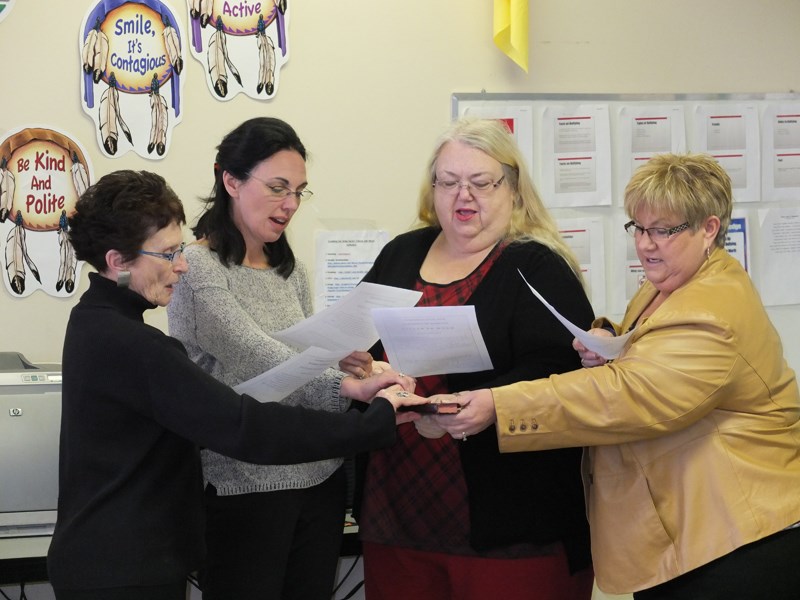 Grasping a bible, chamber executive members Mary Dwernichuk (from left), Dianne O’Brien, Laurel Mackie and Karen MacKinnon are sworn in.