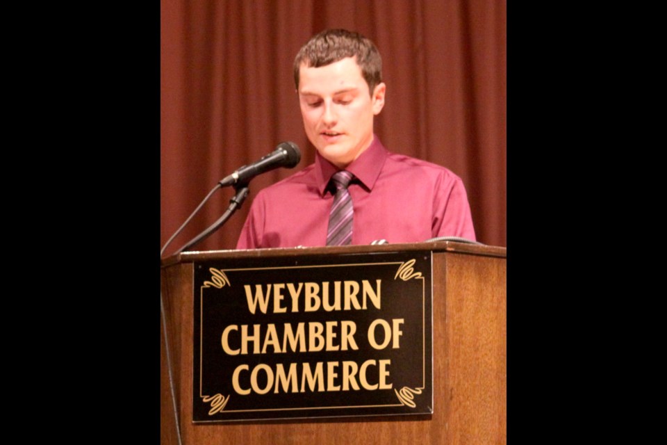 Jake Leguee takes the stage after his father, Russ, to share words as a representative of the younger generation's role in the family farm.
