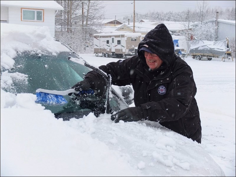The white stuff looked like it was here to stay Monday morning as area residents awoke to frosty windshields and snow-blanketed streets. Colin Campbell (left) dug out his gloves and snow brush on Phelan Avenue while neighbour Felix Flynn revved up the snowblower. Today’s forecast called for more snow.