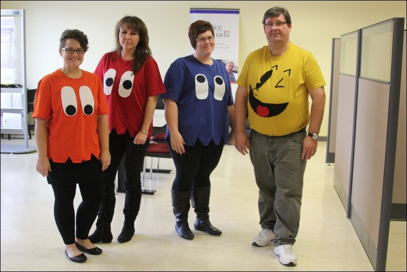 Service Canada employees Krista Eastman (from left), Donna Oulette, Melissa Danis and Joe Bouie dressed as Pac-Man and the ghosts to celebrate Halloween on Friday. Meanwhile, Auvrie Unruh (right) dressed as Elsa from Disney’s Frozen at the Family Halloween Dance, put on by Creighton Recreation and Creighton Community School, Thursday at the Creighton Community Hall. The princess was one of more than 125 children enjoying music, dancing, and of course, candy.