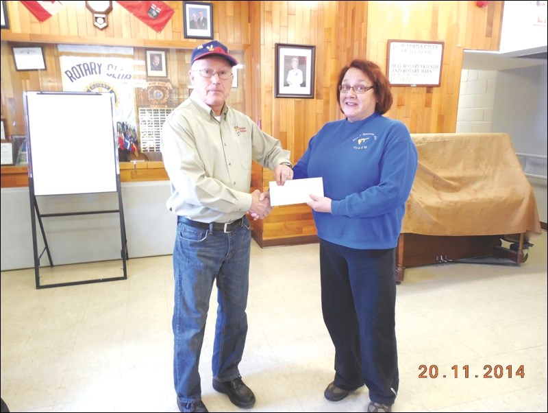 The Rotary Club of Flin Flon last week handed out four donations with revenue from last year’s Operation Red Nose program. Here, Red Nose co-chair Ted Hewitt presents a $3,820 donation to Sheena Reed of the Flinty’s Gymnastics Club. The money will buy new mats and equipment.