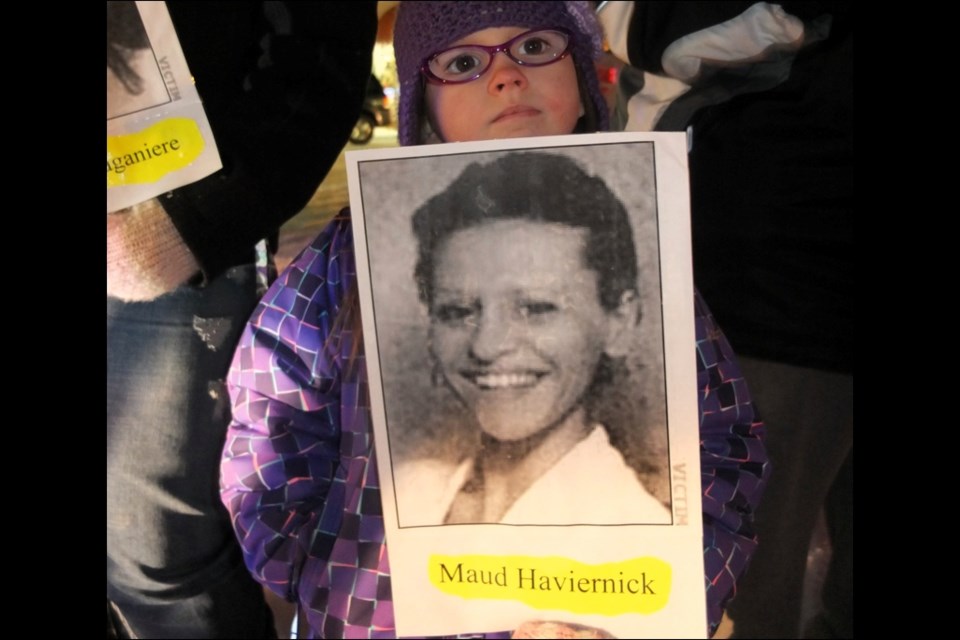 Lily Gieg, 5, holds a picture of Maud Haviernick, one of the Montreal Massacre victims, at the Dec. 6 vigil.