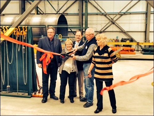 A ribbon cutting ceremony was included in the grand opening celebration marking the completion of a Leading Manufacturing Group Inc. facility in the Battleford industrial area. Taking part in the ceremony were Mayor Derek Mahon (far left) and Battlefords MLA Herb Cox (back). Also taking part were Theresa Bilous standing in for MP Gerry Ritz, LMG president and Lee Gottschlich and Debbie Hudson, administration manager for LMG. Photos submitted