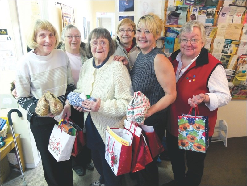 Northern Manitoba’s Order of the Eastern Star branch last week donated more than 80 gift bags to Flin Flon’s Women’s Resource Centre and Friendship Centre. Each bag contains hand-knit slippers along with personal hygiene items such as toothbrushes and combs. Half of the bags also contain a book and a toy for children. Left to right are Barb Hopkinson of the Women’s Resource Centre, Val McAdam, Jeanne Fell (Flin Flon) and Marilyn Johnson of the Eastern Star, Colleen Arnold of the Women’s Resource Centre, and Joanne Wain of the Eastern Star.