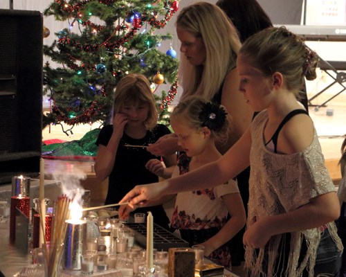 Alida's Old Fashioned Christmas Concert was held on Friday, Dec. 19. Here community members light memorial candles to bring thoughts of their loved ones to the event.