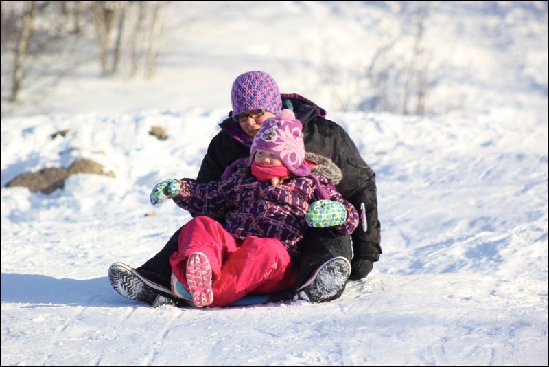 A few brave souls dressed for the near -45 temperatures at the Flin Flon Creighton In Motion Committee’s Sliding Party last Saturday, Jan. 3. Mom Melissa Danis and daughter Caileigh got ready to head down the hill at the Flin Flon Creighton Ski Club chalet.