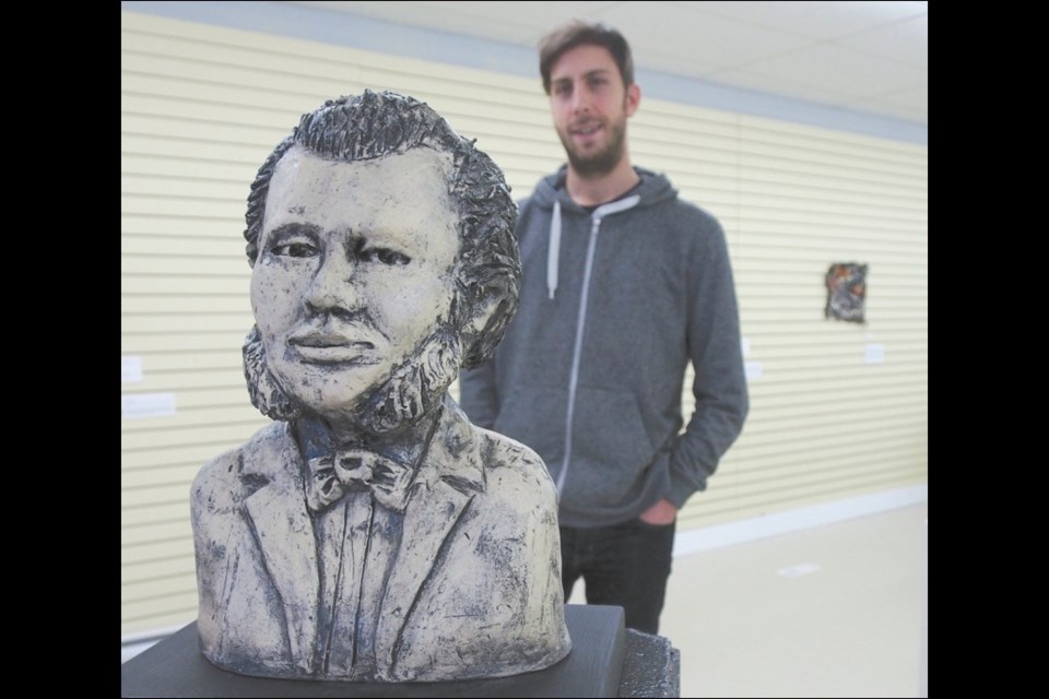 A ceramic sculpture of Louis Riel is one of 15 unique pieces on display at the NorVA Centre as part of the For the Love of Craft exhibit. Mike Spencer, manager of the NorVA Centre, is seen in the background.