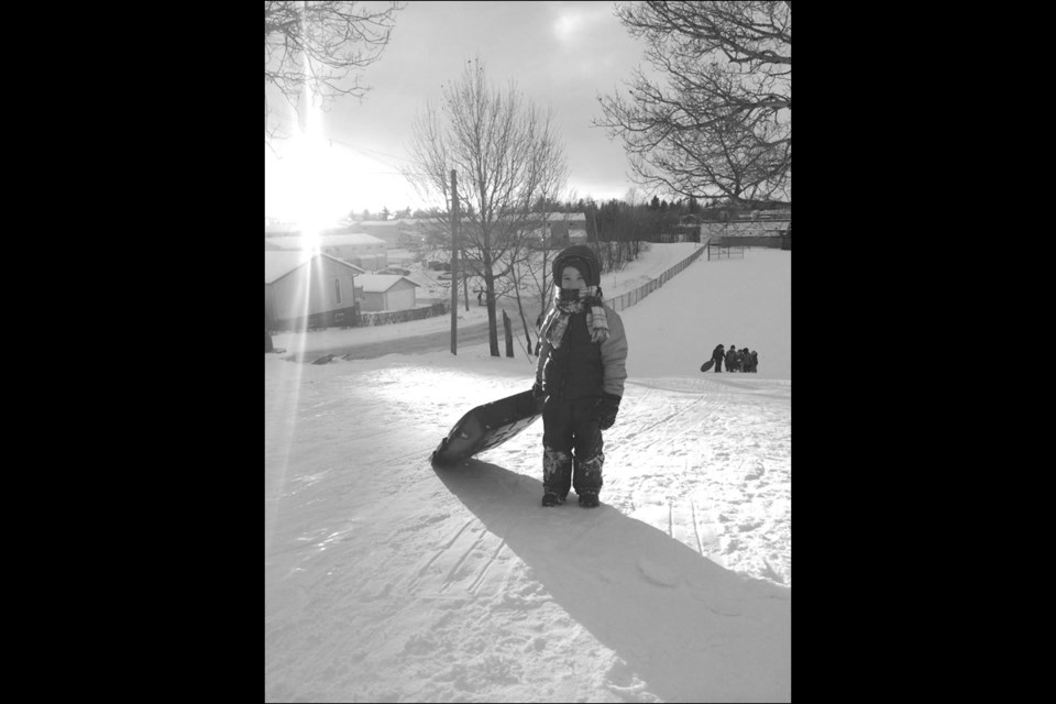 Aaron Suchoplas enjoyed the warm weather Thursday evening with some sliding before the rain came down. Temperatures have been seasonally low, especially compared to last year, this winter and have allowed for more enjoyable winter activities.