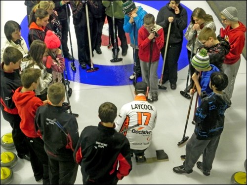 Steve Laycock has the full attention of junior curlers as he shows delivery methods from the hack while on the ice in Unity for the Decisive Farming Curlingville tour.