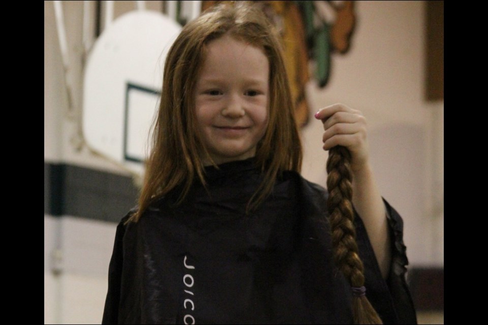 Creighton Community School rallied together to raise $875 for the Canadian Cancer Society after one brave student put out a challenge. Grade 1 student Emma Gardiner-Long said she would cut her waist-length hair if the school could raise $300. Cosmetology teacher Tracy Hovland cut Emma’s hair during a school assembly Wednesday afternoon. Emma’s hair will be donated to a wig program.