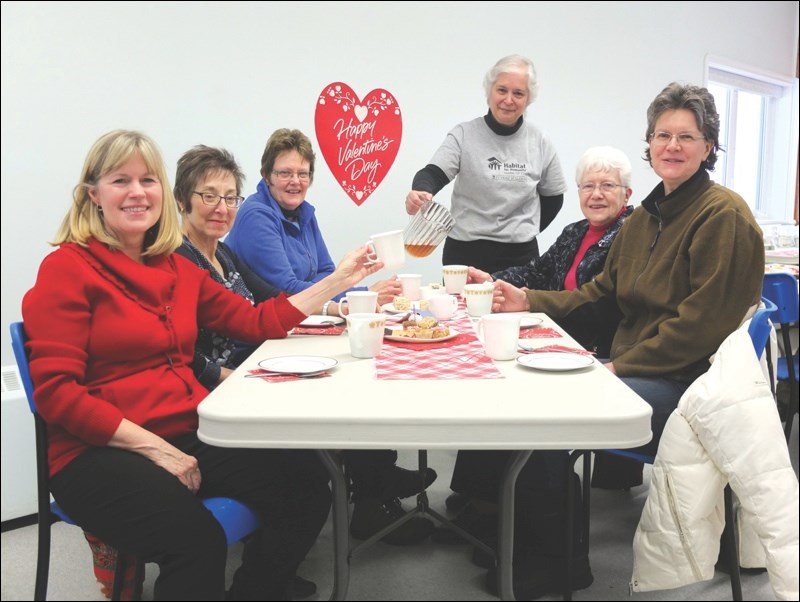 Habitat 53° raised nearly $2,000 with a Valentine’s Day tea at St. Ann’s Roman Catholic Church last Saturday, Feb. 14. Habitat’s Kathy McCormick (standing) served guests that included (from left) Judy Pettersen, Fran Reiben, Jan Modler, Ruth McIntosh and Luanne Berg.