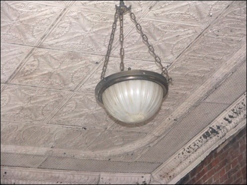 A photo from July 2009 showing the original metal ceiling tiles in place in Battleford’s Opera House. They have been removed, numbered, and sent for sandblasting and powder coating. They are to be re-installed as part of the refurbishing of the historic venue that makes up the top storey of Battleford Town Hall.