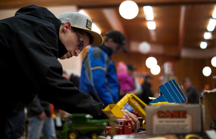 John Gilbert, above right, examines some of the older farm toys.