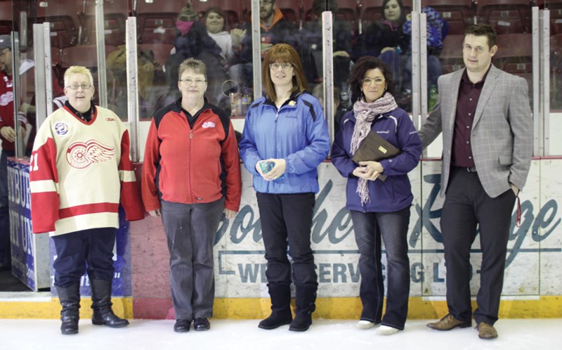 The SaskEnergy Volunteer Awards were presented at the final regular season home game of the Weyburn Red Wings on February 21. Pictured (l-r) award recipients Joanne Daunheimer and Val Tribiger, Weyburn SaskEnergy rep. Dawn Haines, SaskEnergy Community Involvement Leader Shannon Doka of Regina and Red Wings’ office manager Ryan Gibney.