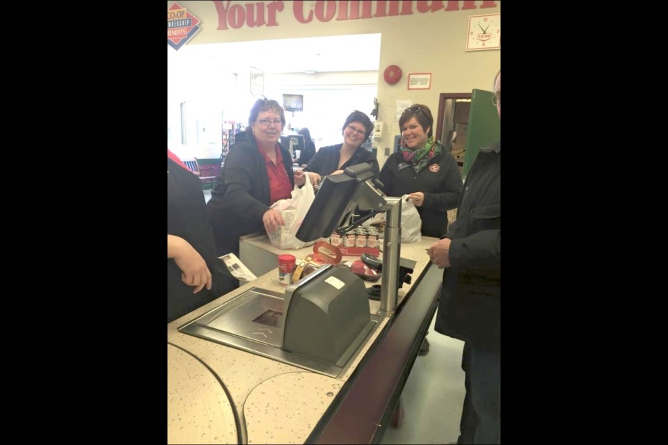 Flin Flon Kinettes Diane Therien (from left), Kelly Oswald and Melissa Danis bagged groceries at the North of 53 Co-op on Saturday, Feb. 21, as part of Kin Canada’s National Day of KINdness. A few Kinettes also carried out the random act of kindness at Eddie’s Family Foods.