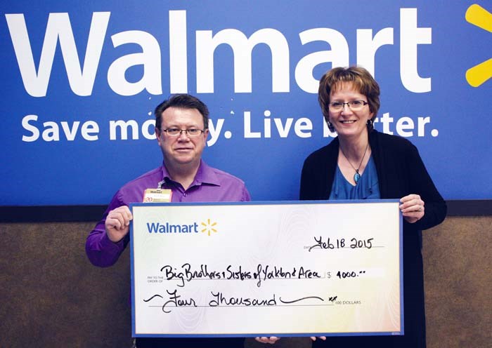 Russell Haugerud, Walmart assistant manager presents Irma van de bon Nicol, executive director, Big Brothers Big Sisters of Yorkton and Area with a cheque for $4,000. The Walmart Women in Retail organization raised $2,000 with their Show and Shine car show August 9, 2014 and Walmart matched it.