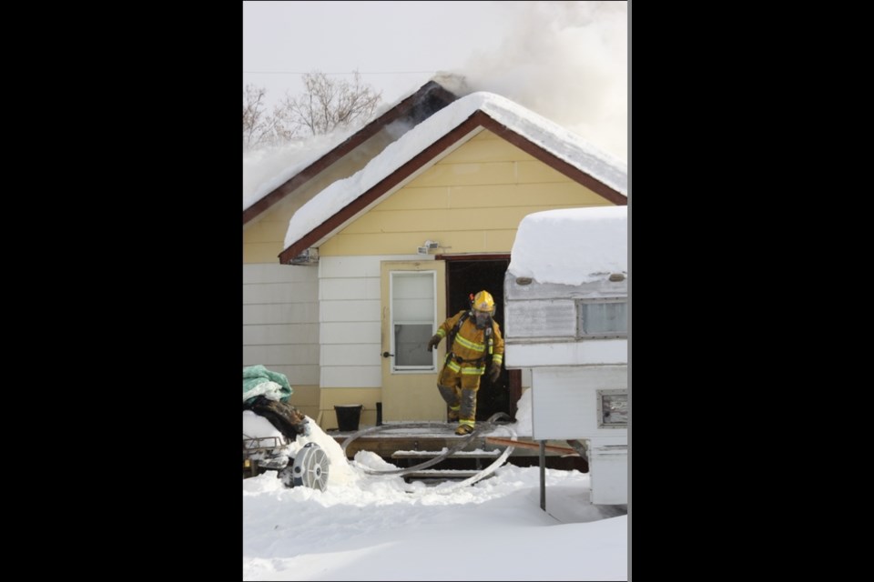A firefighter exits the home.