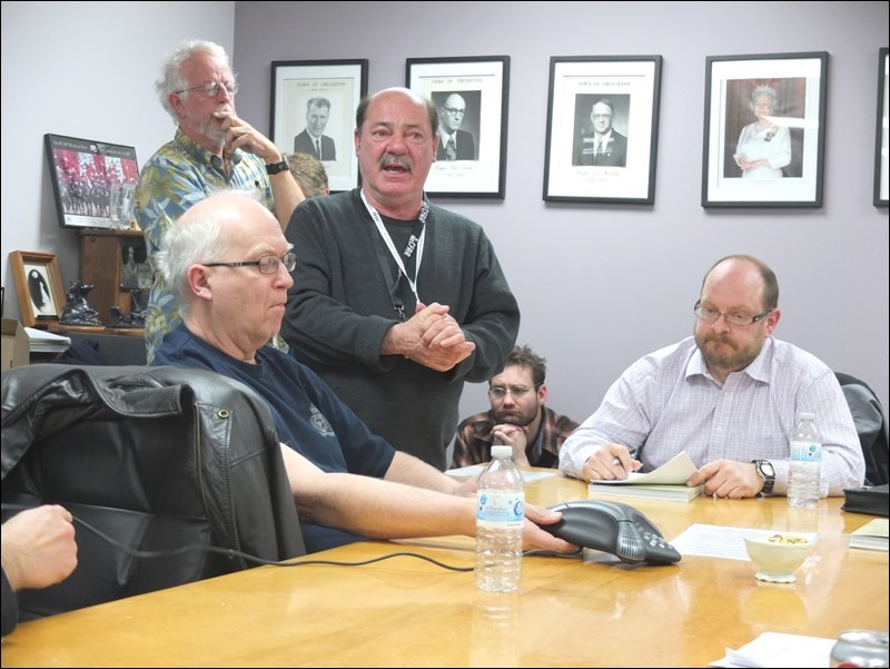 Mike Krizanc (standing, front) was the public face of NWMO in Creighton. He is pictured at a 2014 meeting of the Community Liaison Committee, a bridge between the public and NWMO, with members Don Aasen (front), Buz Trevor (standing, back) and George Trevor (seated, right).