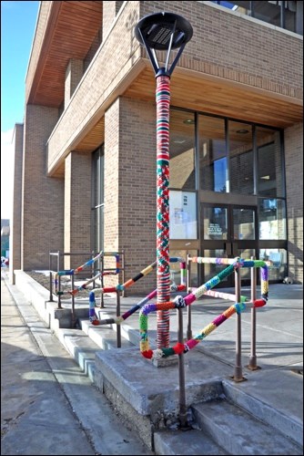 Yarnbombing, guerrilla knitting, kniffiti, urban knitting, yarnstorming or graffiti knitting, whatever you call it, it's a growing movement in street art that has come to North Battleford. City Hall has enjoyed a colourful decoration through the winter, which seems to have held up well. Photo by Jayne Foster