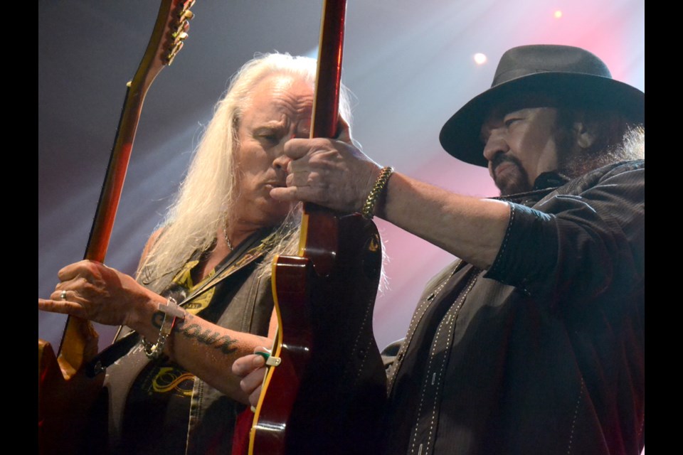 Guitarists Rickey Medlocke and Gary Rossington rock out with some guitar solos.