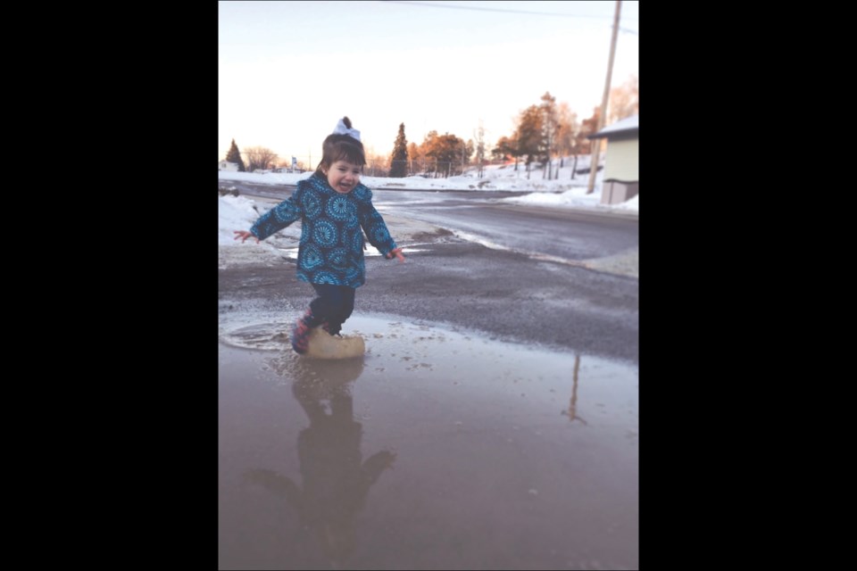 Charlie Gummerson, 2, took full advantage of the recent sunshine and melting snow as she played the afternoon away in the Aspen Grove area.