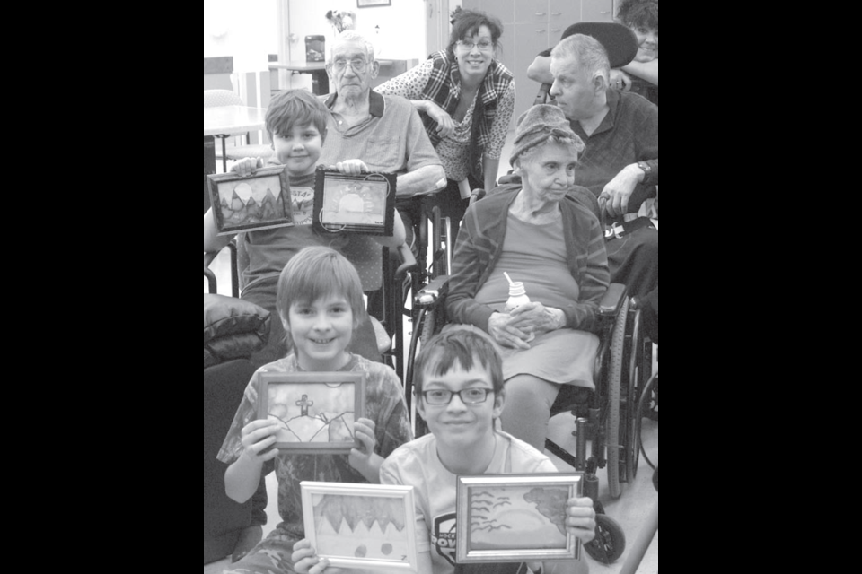 École McIsaac School Art Club members Luan Gouws (back), Caleb Baynton (middle) and Eli Plamondon (front) recently donated paintings to the Northern Lights Manor. With frames donated by the NorVA Centre, each student created two watercolour paintings and gave the better of their works to the manor. The students pictured also presented paintings by Zaden Koczka and Magnus Pearson.