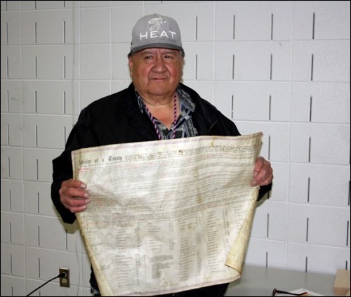 Treaty Keeper Ben Wuttunee brought an original document of Treaty Six to Connaught School last week for the presentation of a framed copy of Treaty Six and the official Government of Canada apology for residential schools. Photo by Brian Quinn