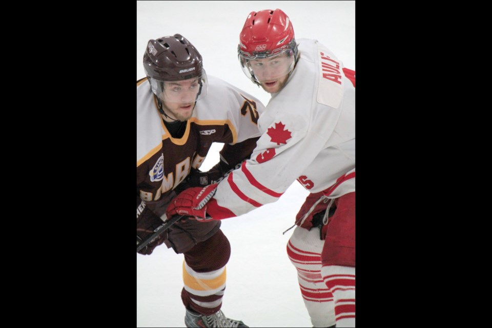 Flin Flon centre Parker Evans-Campbell looks past Notre Dame centre Sam Aulie during Tuesday’s game.