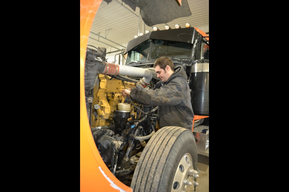 Heavy duty transport mechanic Nathan Miller works on a Peterbilt truck at his NGM Mechanical shop northwest of Lloydminster.