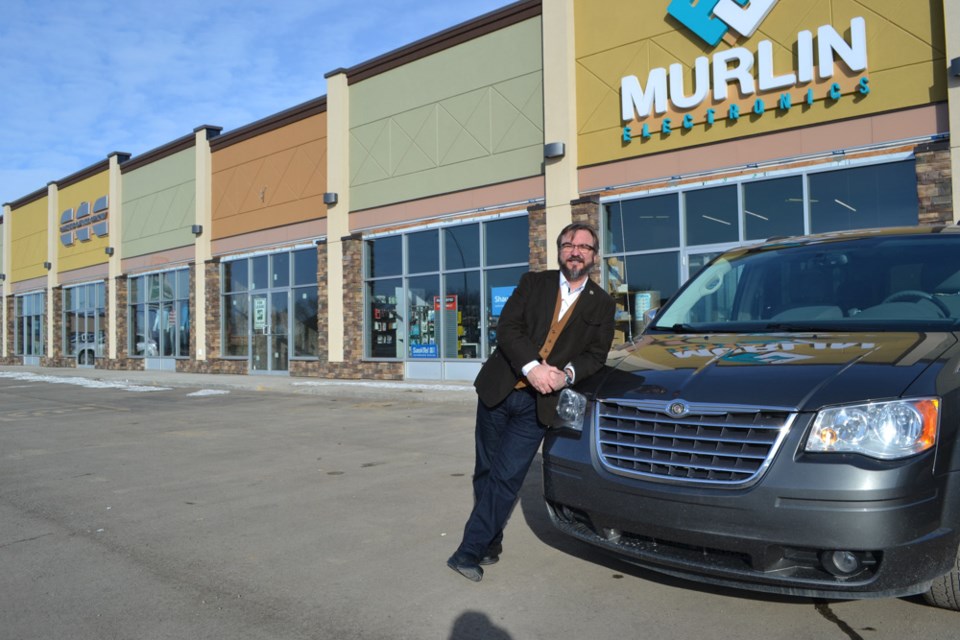 Mayor John Enns-Wind strikes a casual pose at the new East Crossing strip mall near Walmart. The mall is next to the construction site of the future home of Energy Dodge. Plans for a new big box retailer are expected to be announced in the coming weeks near these developments.