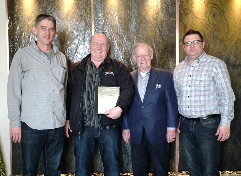 Duane Walkeden (left) and Wade Ashworth (far right) from Cenovus, presented Wayne and Don Bell from Systems Scaffolding with their award for Health and Safety Stewardship.