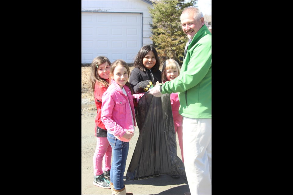 Rhyanne Rice (left), Rene-Marie Laderoute, Cherish Gunville and Alexis Volk helped Creighton Community School substitute teacher John Clark pick up trash.