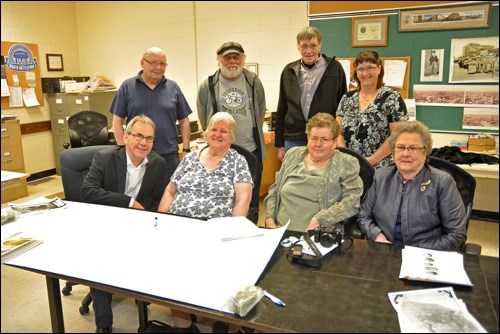 On hand to view the photos Margaret Usher, shared are: top - Bill Wells, Ken Sanders, Harvey Cashmore, Tammy Donahue Buziak (archivist); front - Mayor Ian Hamilton, Margaret Usher, Alice Grove and Leola Macdonald.