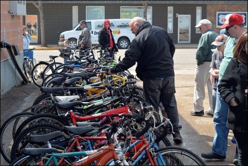 Wheel Deals — The Battleford Kiwanis Bicycle Auction was held in the North Battleford Legion parking lot Saturday afternoon. Around 90 bikes were auctioned off for a total of $2,450, all of which will be turned around and donated to the community through various groups. The Kiwanis Club is also on the lookout for new members. You can contact Dave Eckel at 306-445-5351 if you’re interested in joining. Photo by Craig Beauchemin