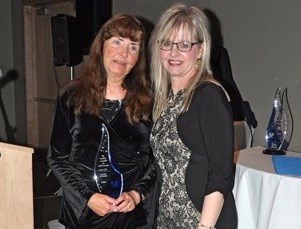 Linda Shynkaruk presents the Community Champion Award to Millie Blixrud.