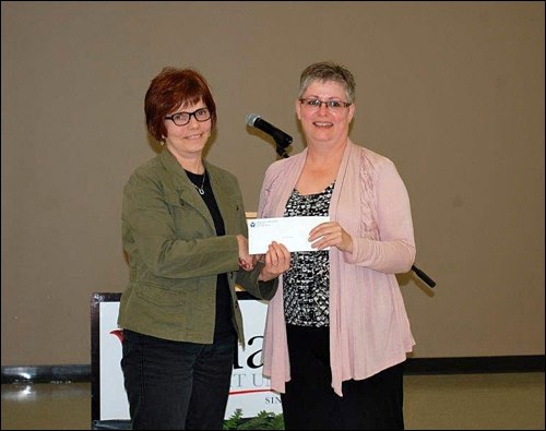 Evelyn Cooper presented Karen McCaffrey with her long-term service award for 20 years of service as a board member for the Edam Credit Union.