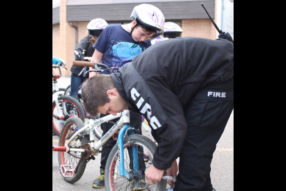 Firefighter Travis Morash checks bikes for optimal tuning.