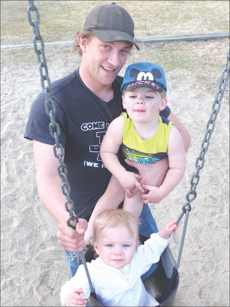 Travis Karcha, son Damien, 2, and daughter Tessyln, 1
