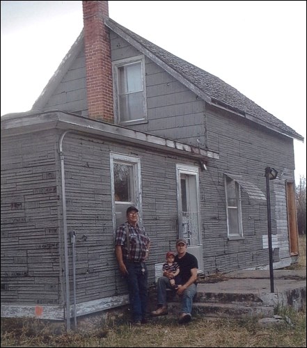 Three generations of Moores in front of the old Grenfell house — R. Gordon Moore and Robert and Corin Moore.