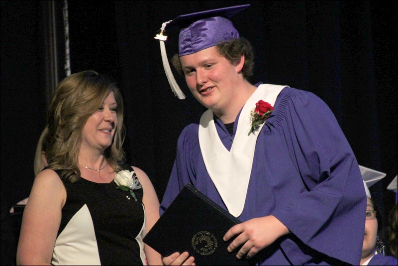 Zackary Ames graduated at the top of the class. He gladly accepted his diploma from Frontier Collegiate Institute principal Dodie Johnston.