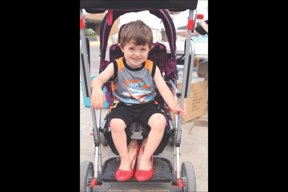 Lucas Rainville proved you’re never too young to stand up (or sit down, in this case) for what is right. The three-and-a-half-year-old sported his mom’s red high heels at Pioneer Square for a few moments for the Walk a Mile in Her Shoes campaign.
