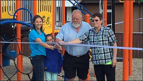 Bayer CropScience representative Teresa Partyka Bowie, Madison Bowie, Blaine Lake mayor Andy Ciona and Blaine Lake playground committee member Bev Breland perform the ribbon-cutting honours at the new playground June 17. Photos submitted.