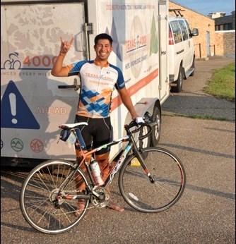 oey Dominguez gives the "Longhorn" sign representing the University of Texas, the home base for the Texas 4000 for Cancer cycling team currently on a 70-day journey from Austin to Anchorage, Alaska. Photo by John Cairns